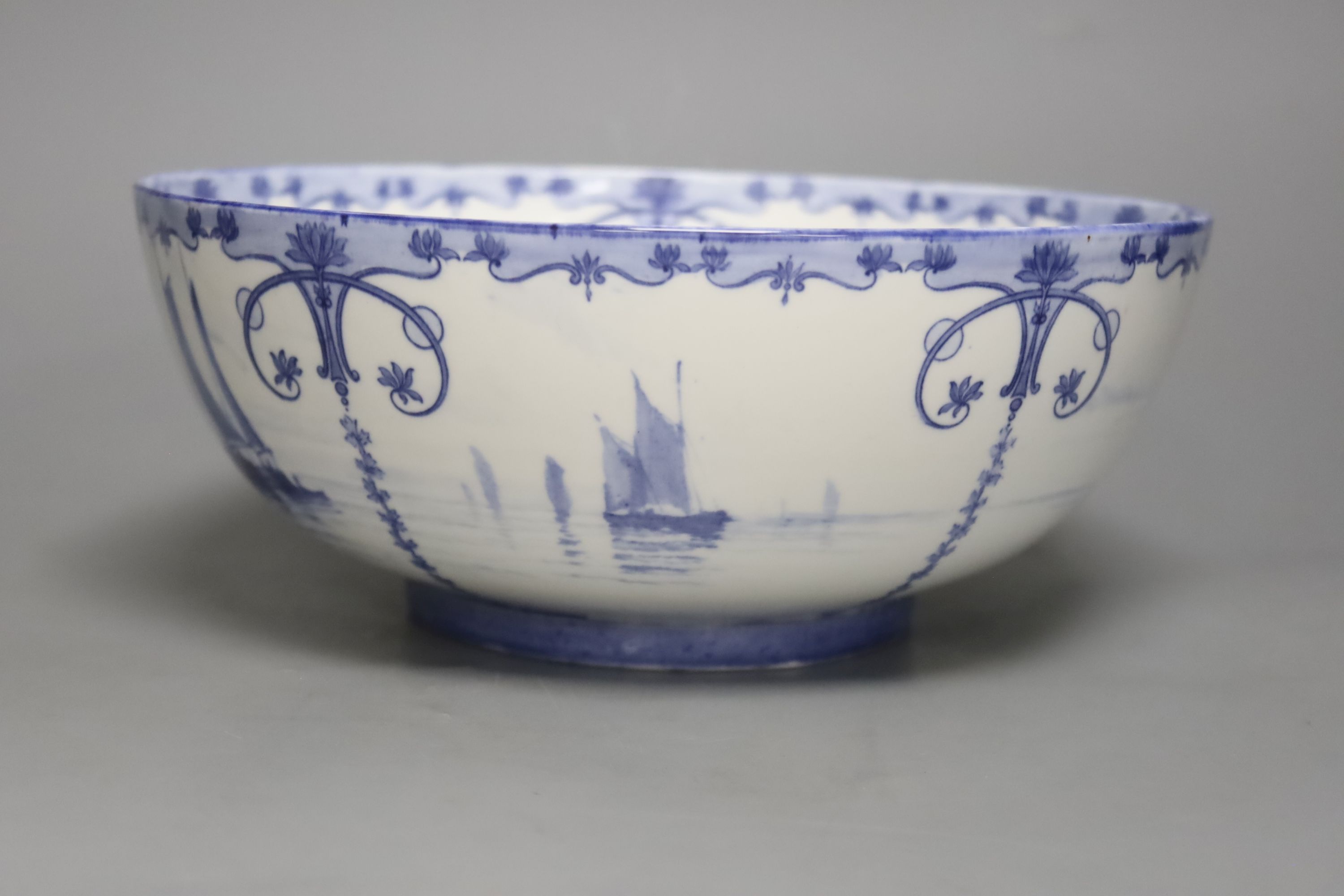 A Royal Crown Derby blue and white bowl painted with sailing scenes, by W.E.J. Dean, diameter 23cm
